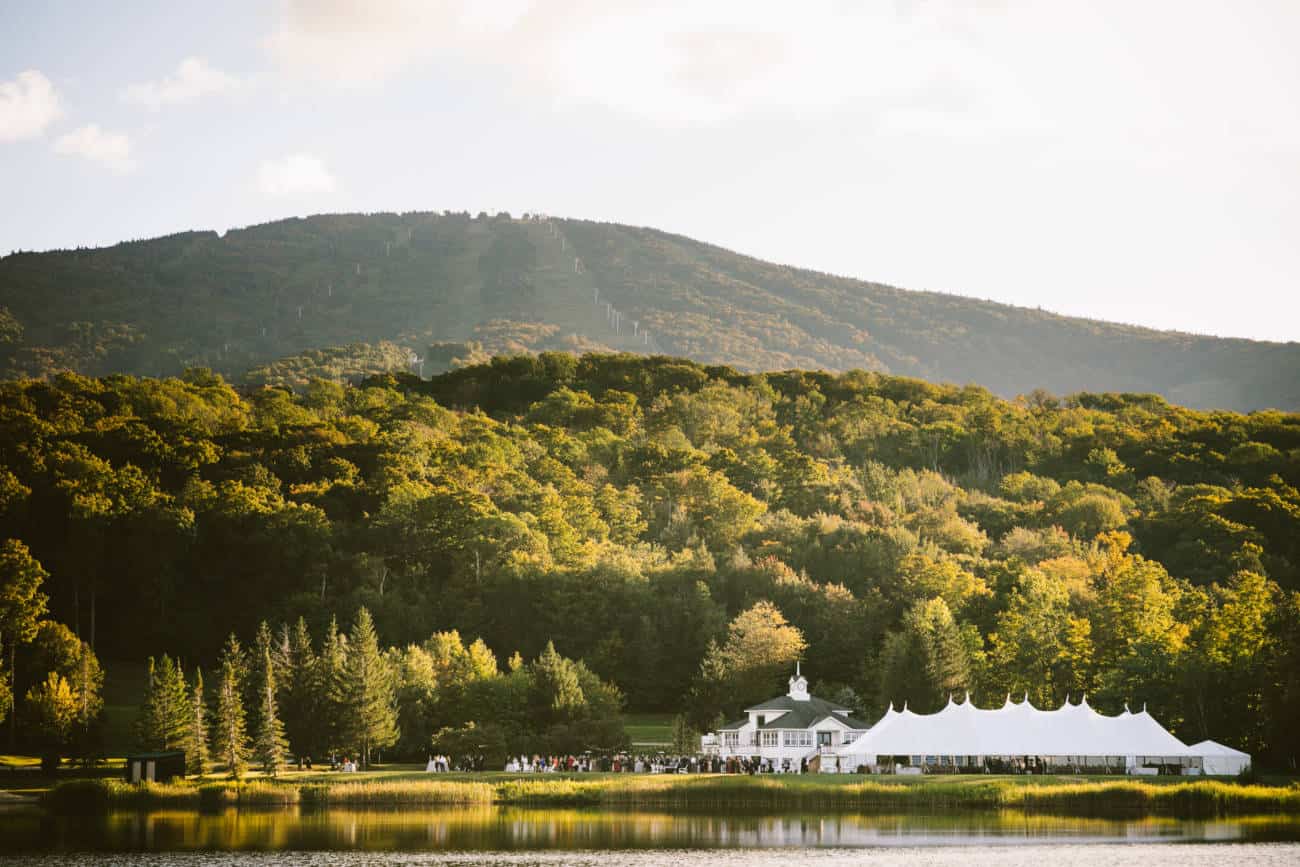 Stratton Mountain Resort Wedding Photos Reception Tent in front of Pond with Mountain and Sun in Background