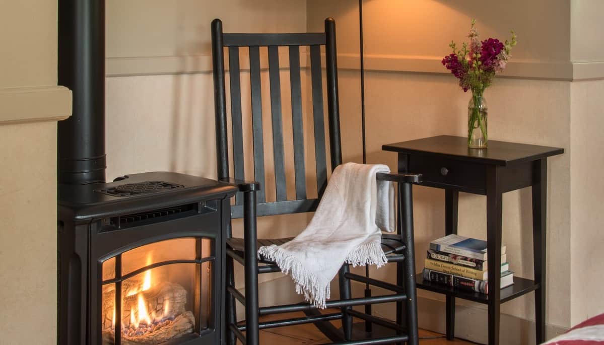 Brass Lantern Inn - Cozy Rocking Chair with Wood Stove