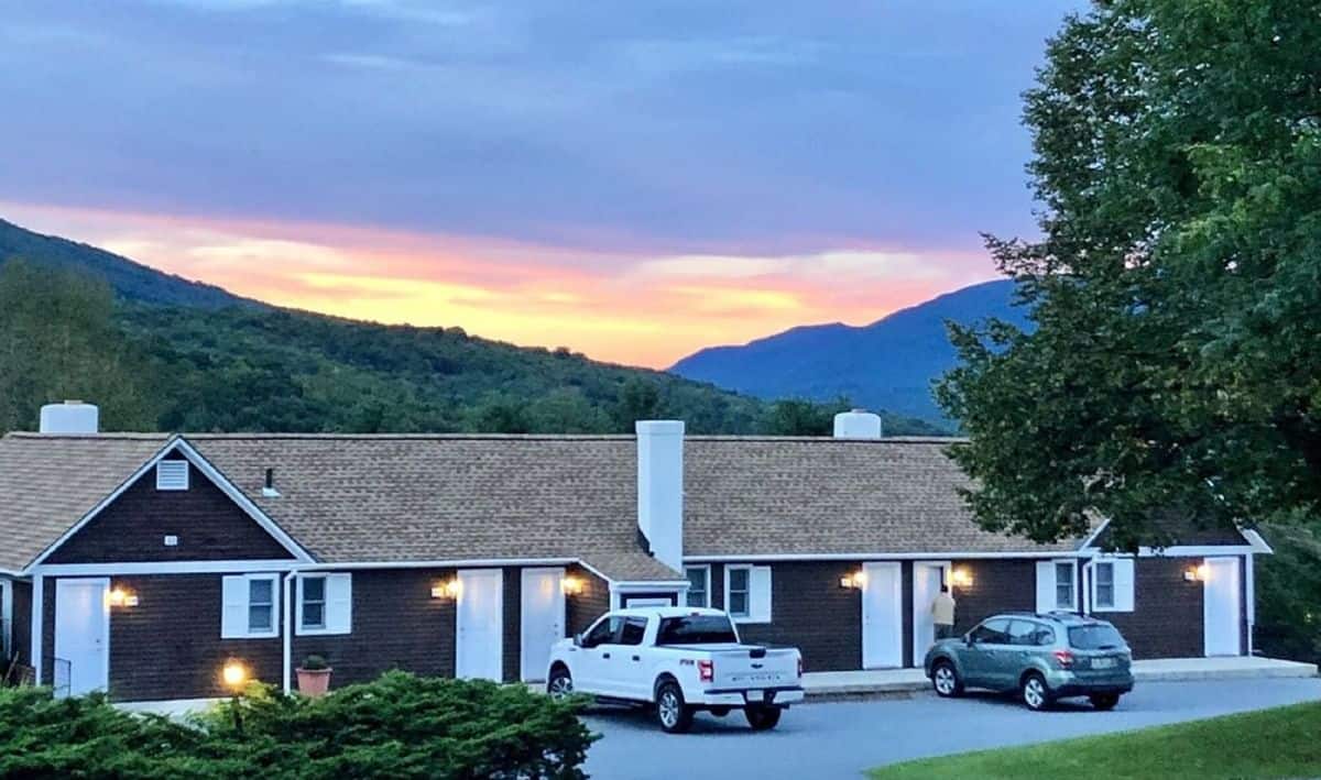 Manchester View - Sunset with Mountains, Building, and Parking