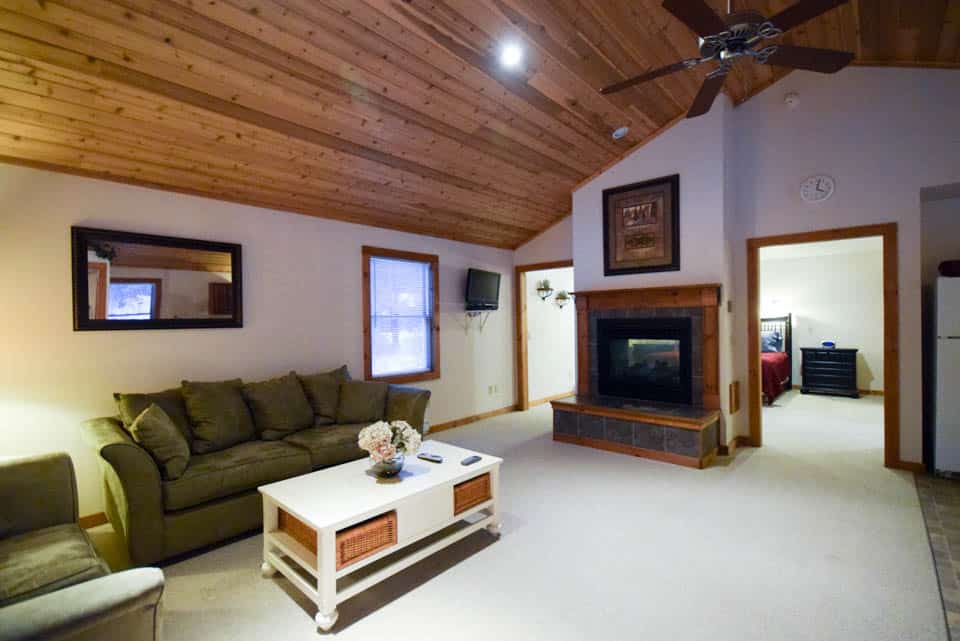 Stowe Cabins in the Woods - Large Living Room with Double Sided Fireplace to Bedroom