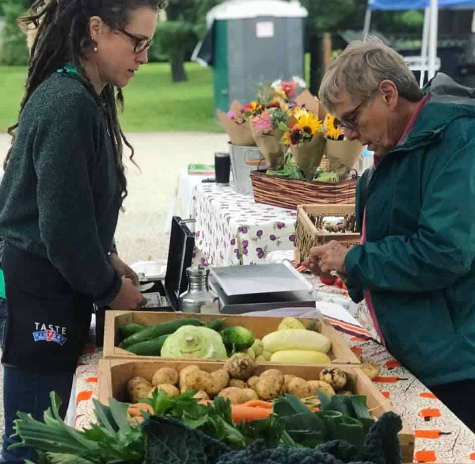Middlebury Farmers Market Vendor and Customer with Produce